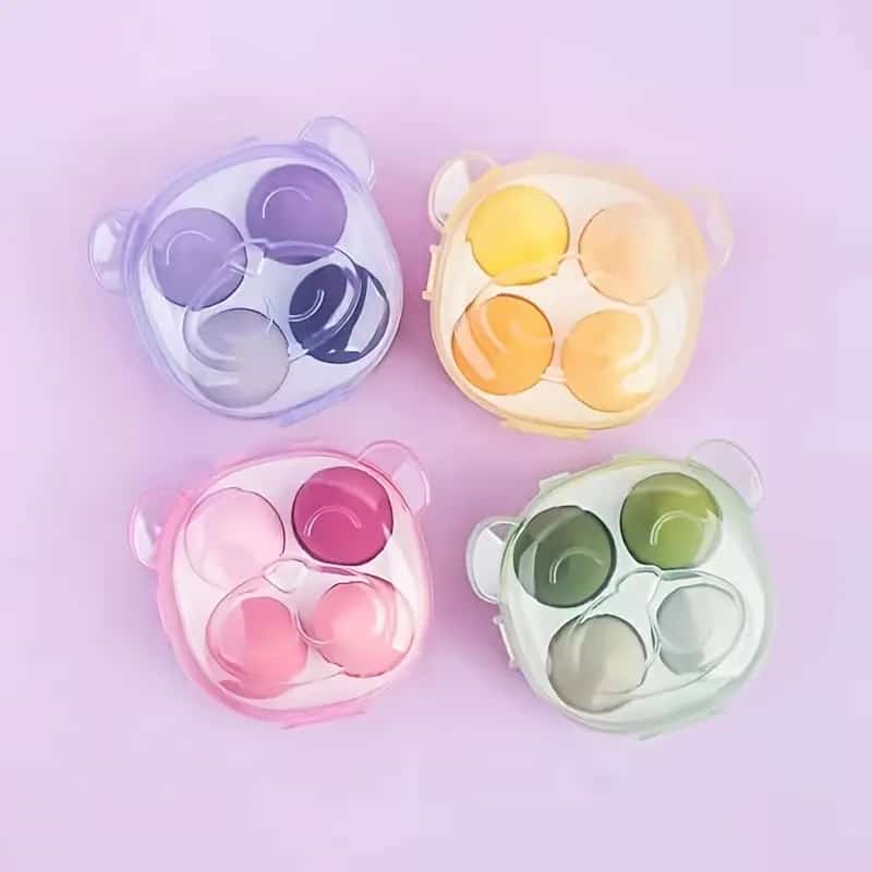 Makeup sponges or beauty blenders in bear-shaped storage boxes.